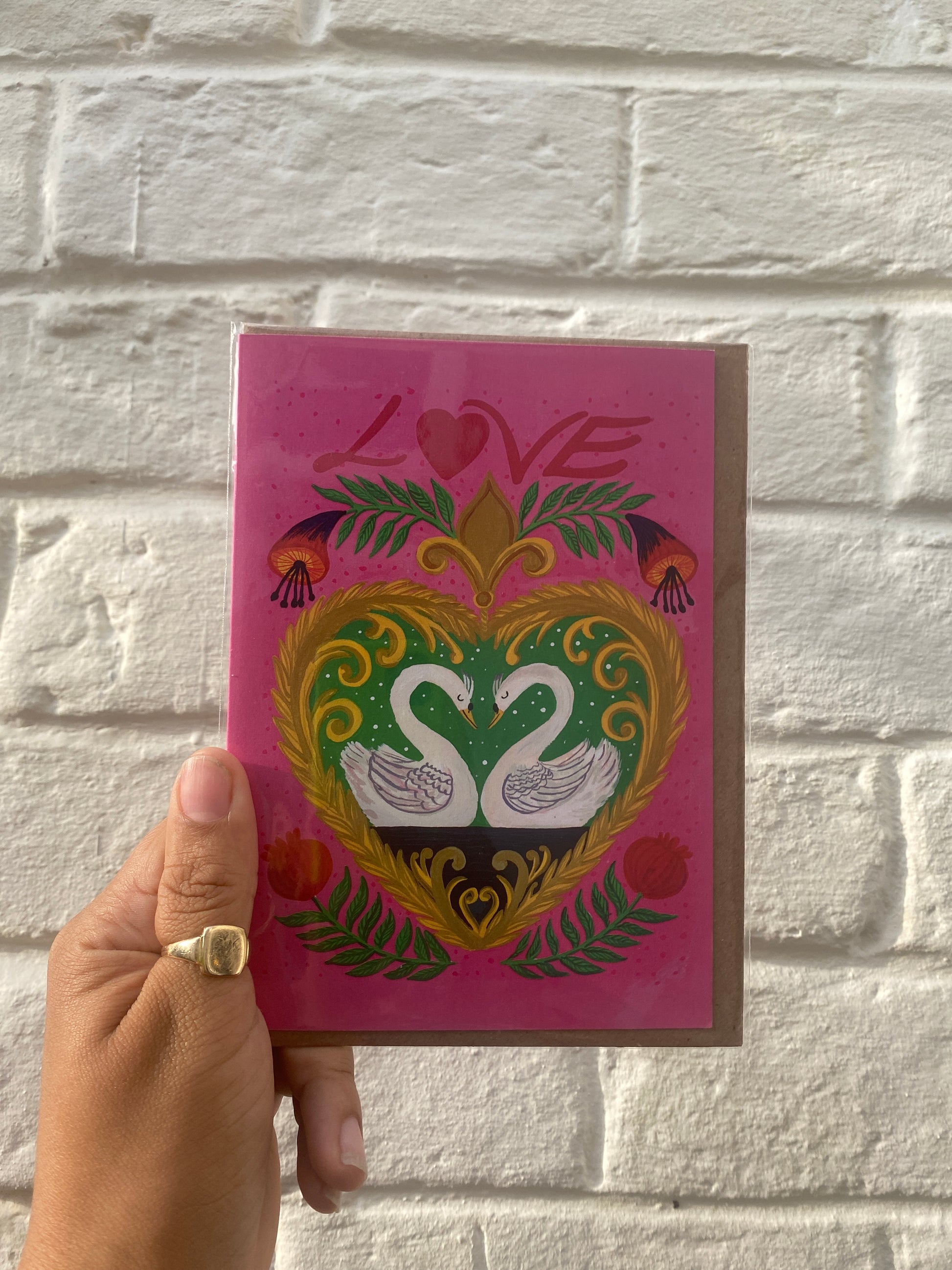 Elegant handmade card featuring swans, a heart-shaped border, and pomegranates, perfect for Valentine’s Day or romantic gift