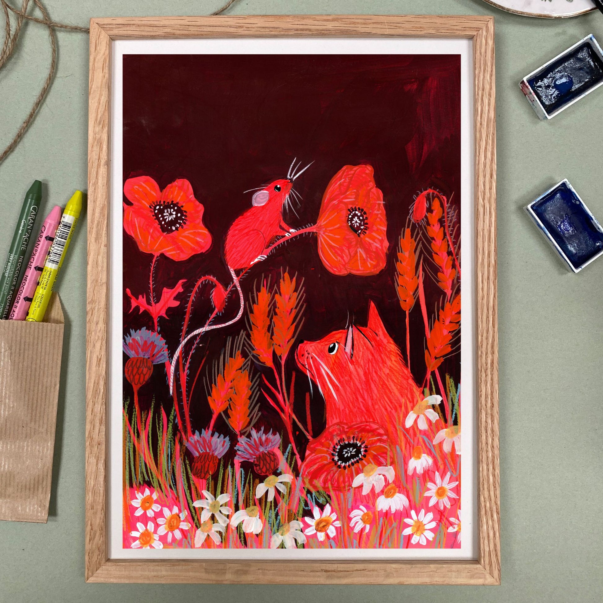 Framed artwork with red animals and flowers on a dark background