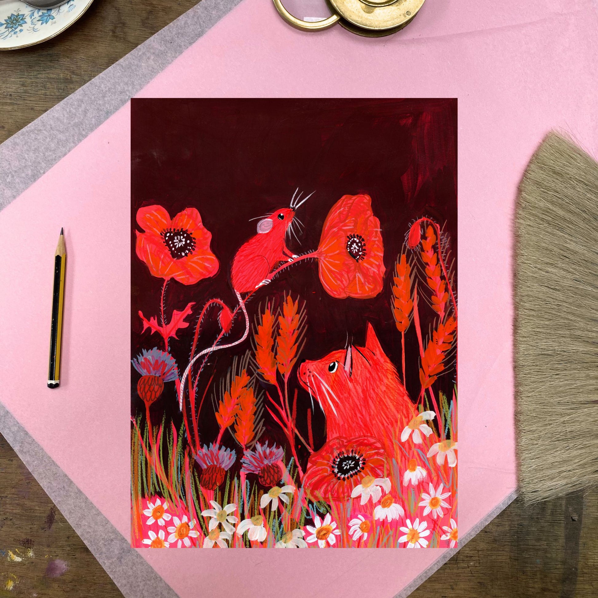 Artistic depiction of red foxes and flowers on a pink surface with a pencil.