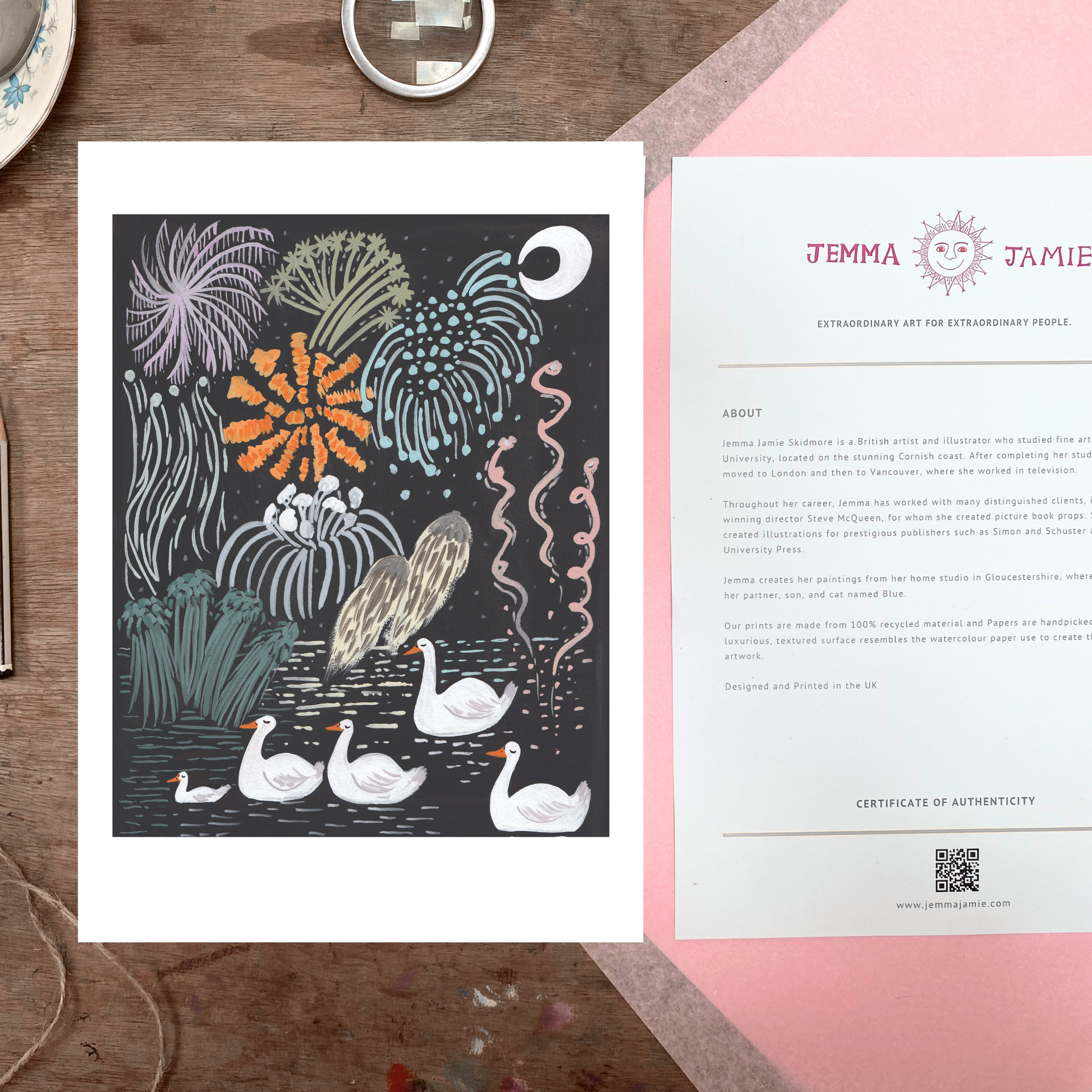Art print with swans and plants on a wooden surface, accompanied by a certificate of authenticity.