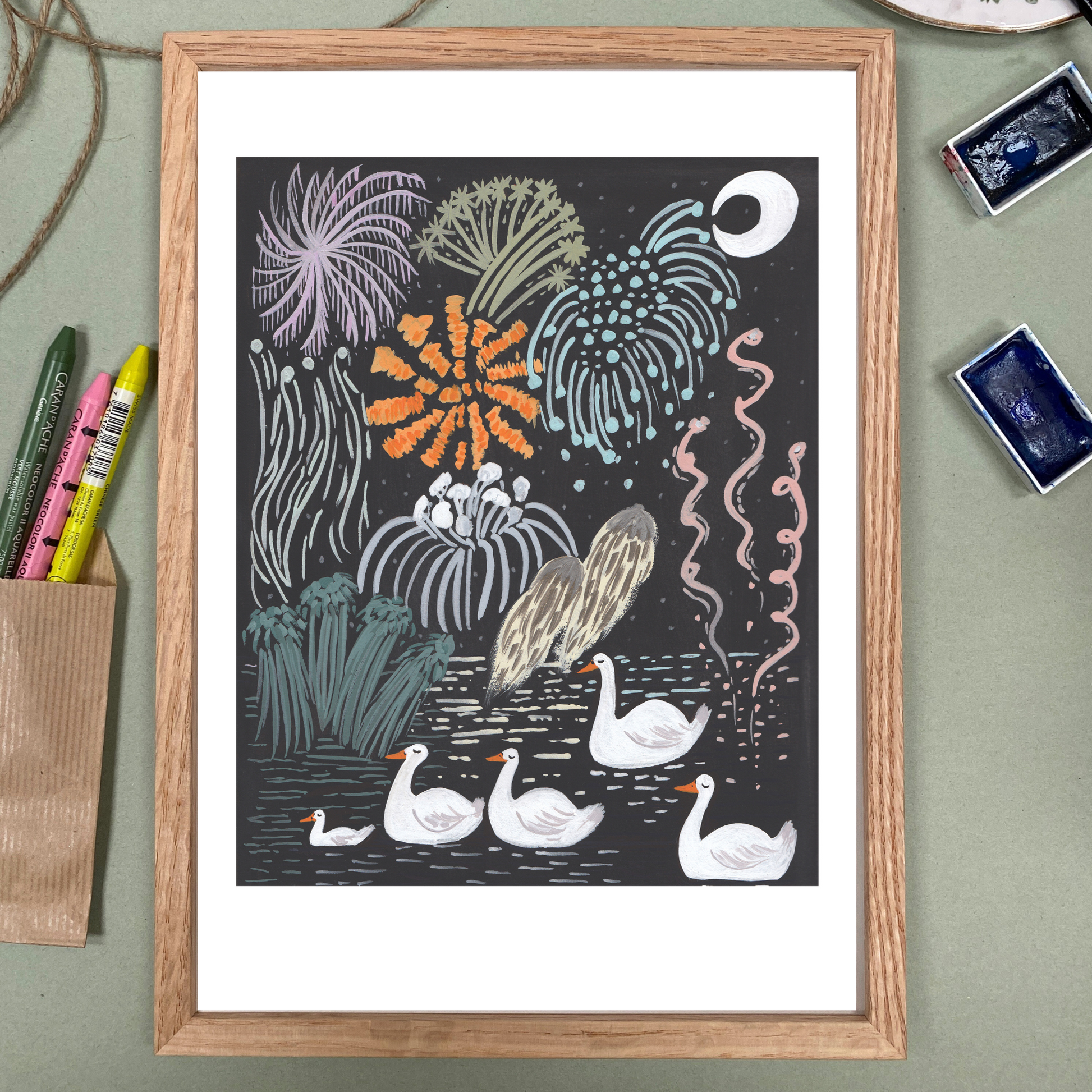 Framed artwork of a nature scene with swans and fireworks on a dark background.