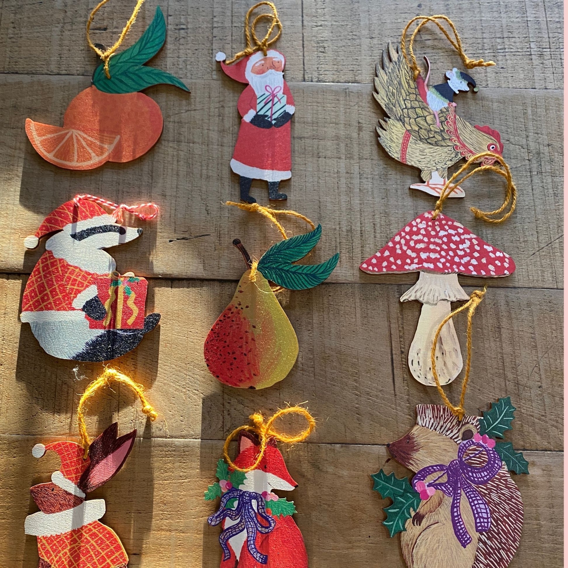 Collection of wooden Christmas ornaments on a wooden surface