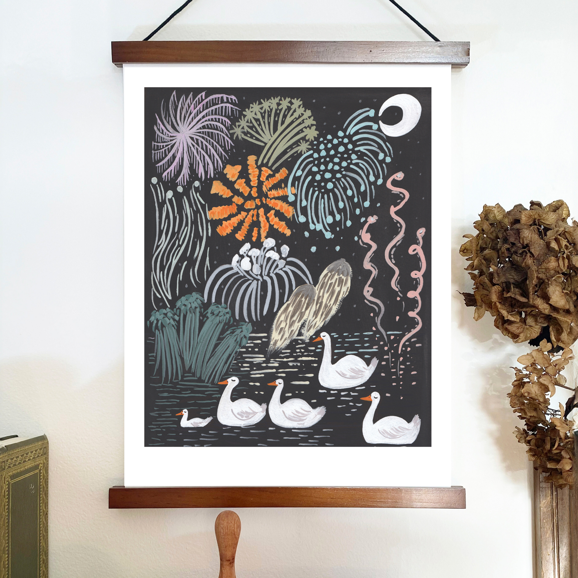 Decorative poster with swans and underwater plants on a wooden frame against a white wall.
