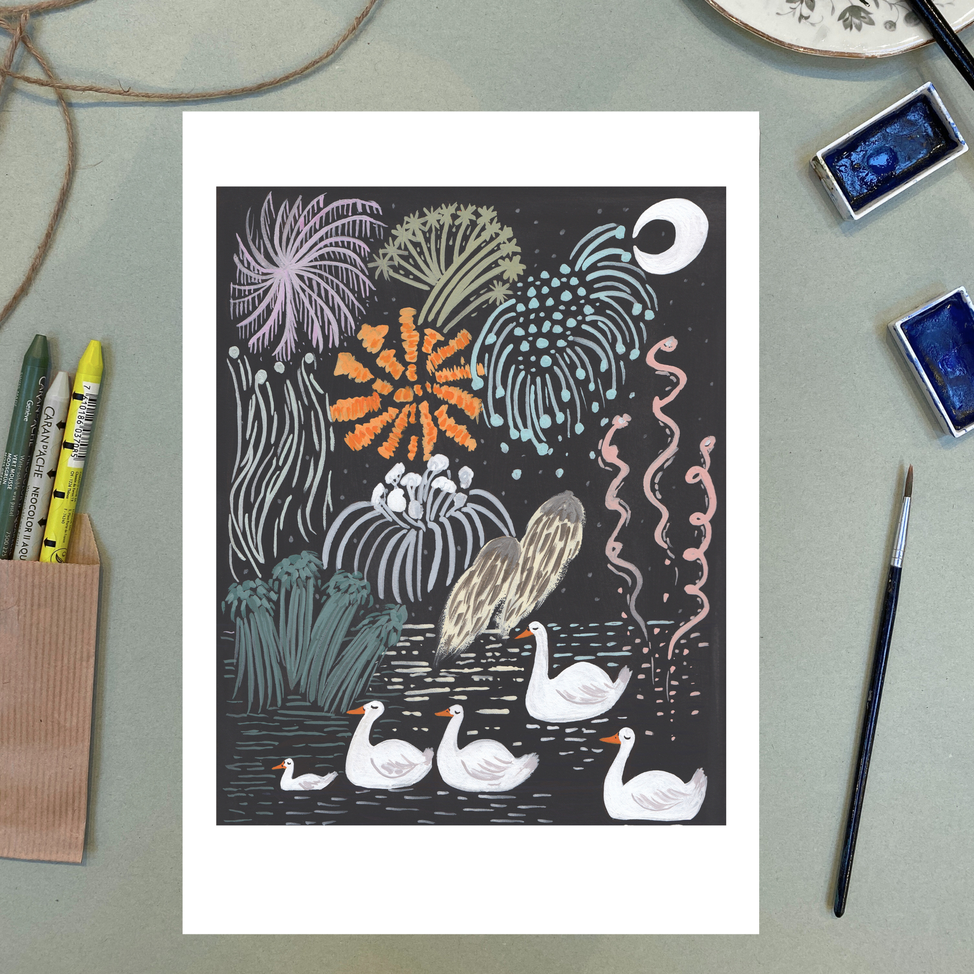 Illustration of ducks and underwater plants on a dark background, displayed on a light green surface with art supplies.