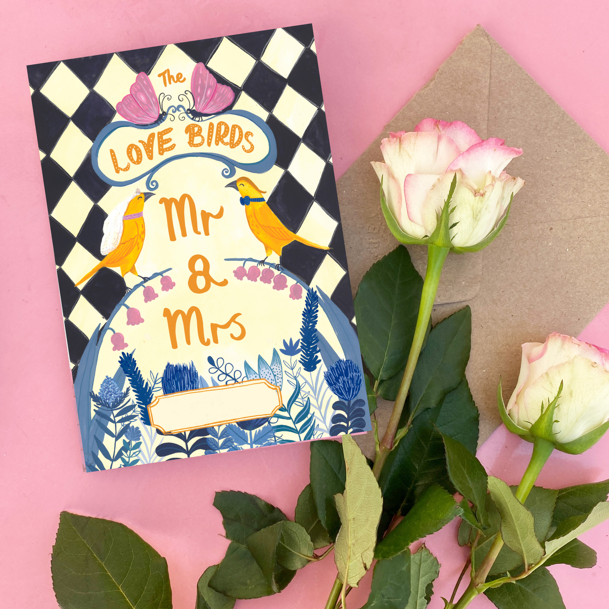 Greeting card with 'Mr & Mrs' text and flowers on a pink background